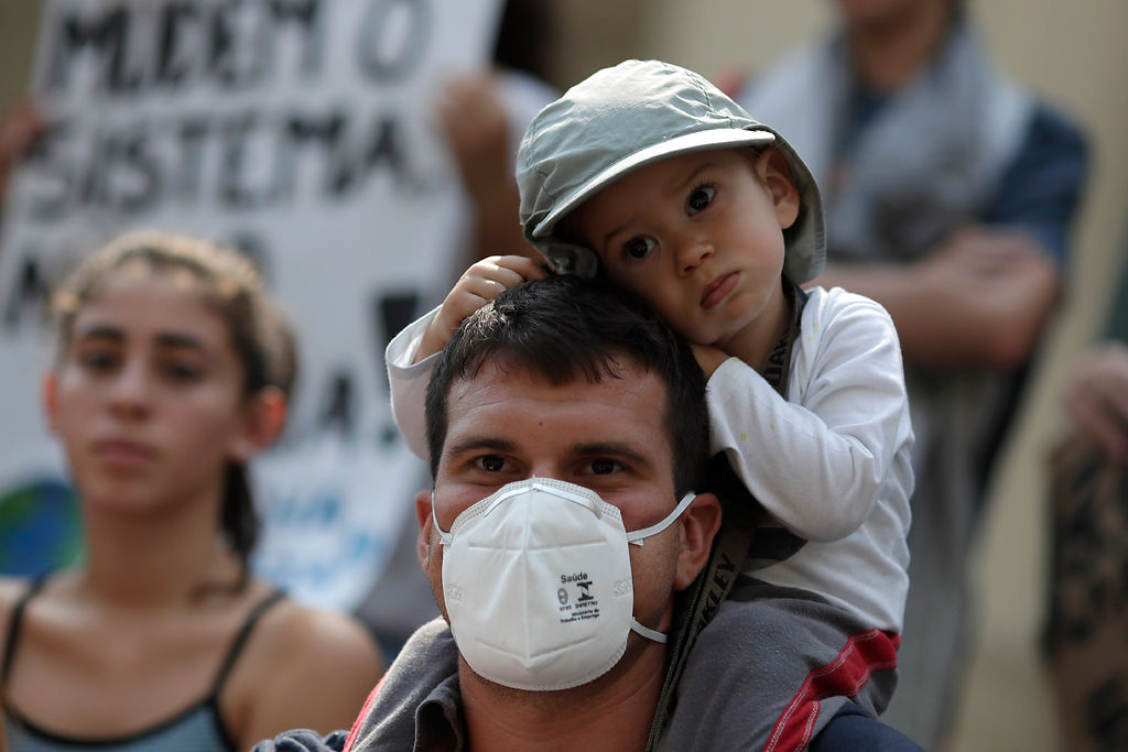 A father with his son attend a global protest on climate change in Rio de Janeiro, Brazil